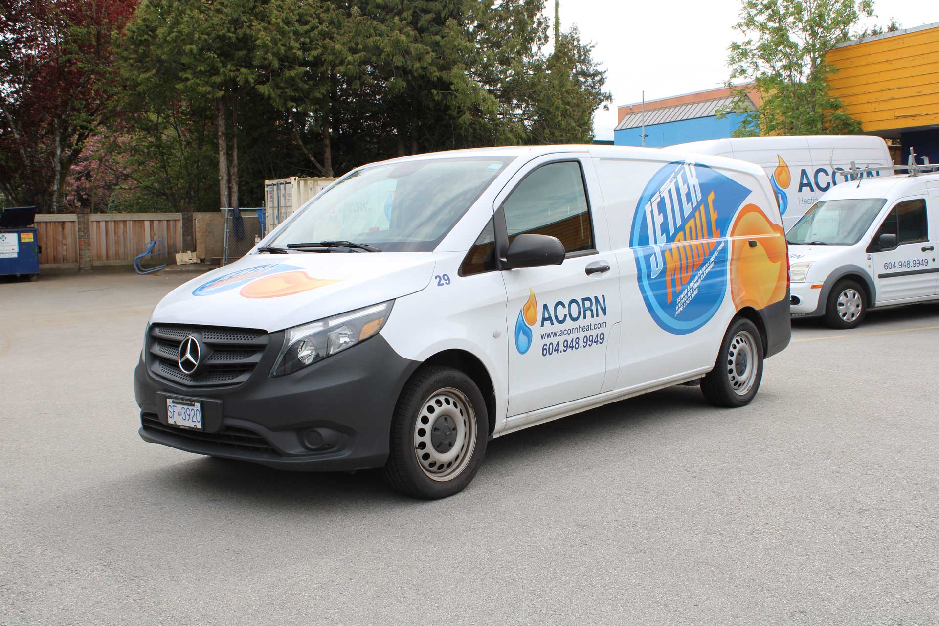Acorn Heating and Plumbing service van labeled ‘Jetter Mobile’ parked outside company facility.